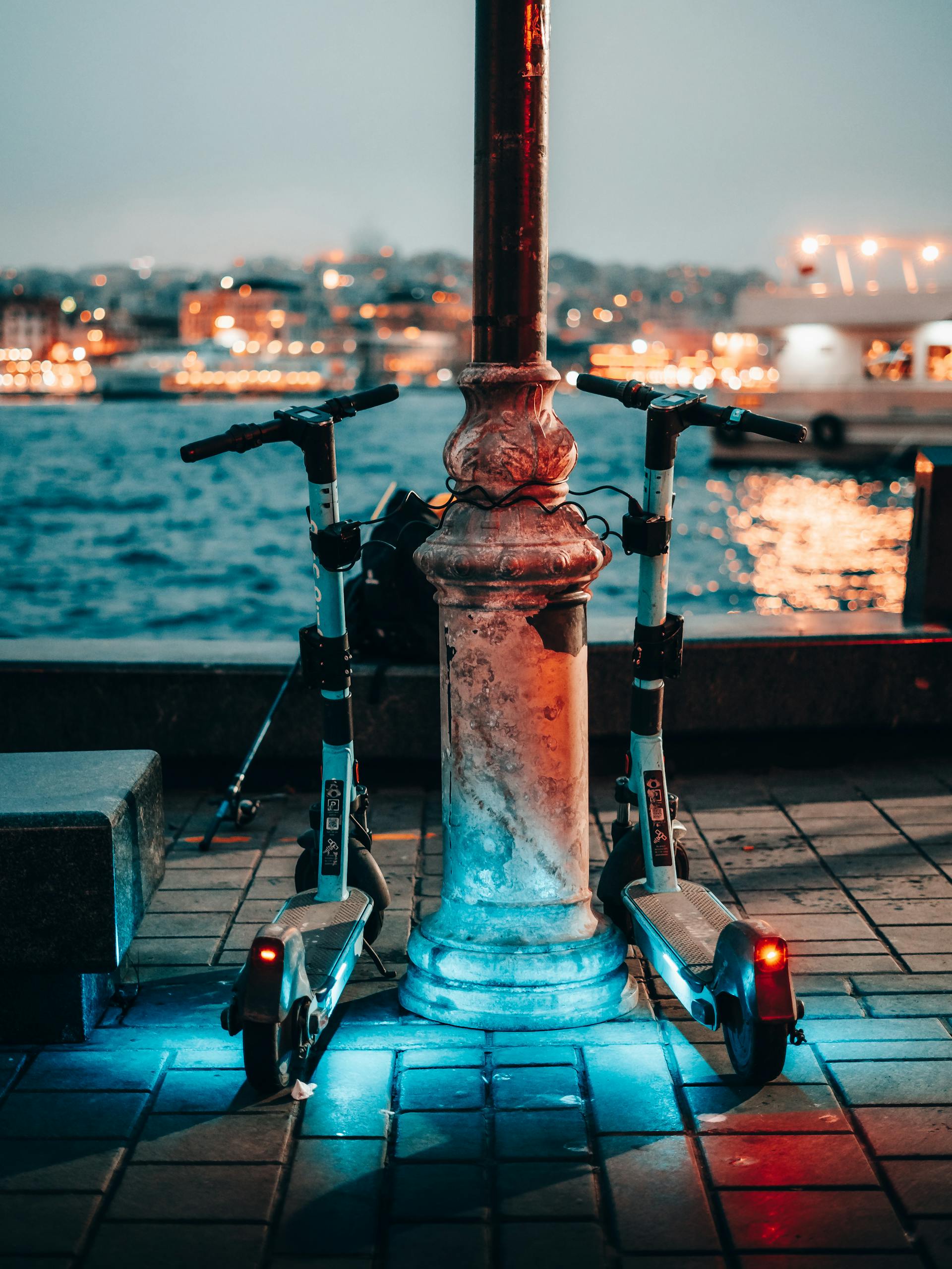 Electric Scooters by Pole on Promenade